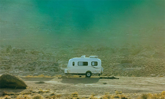 Book of the Year Sacrament cover: unhitched trailer in desert.