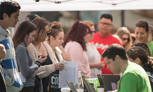 Students at booth at Cougar welcoming days
